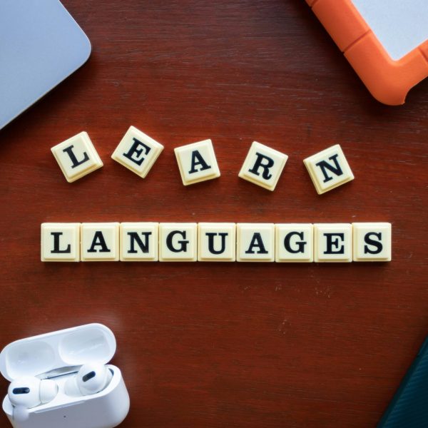pexels-photo-14814047-14814047 Flat lay of language learning materials with gadgets promoting education.